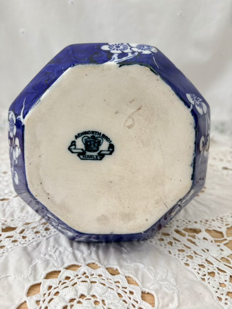 Octagonal ceramic dish with blue floral patterns on a white lace doily