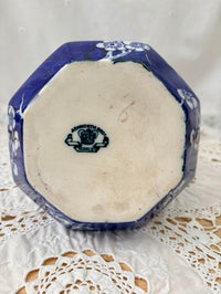 Octagonal ceramic dish with blue floral patterns on a white lace doily