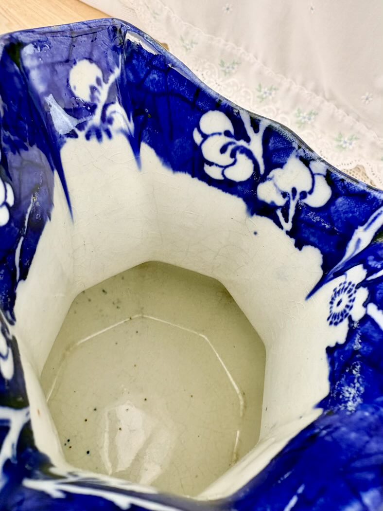 Close-up of a blue and white ceramic vase with floral patterns