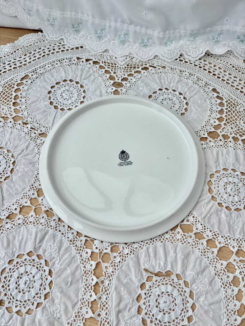White ceramic plate with a logo on a lace tablecloth