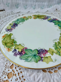 Decorative plate with grapevine design on a lace tablecloth