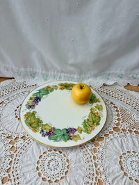 Decorative plate with fruit design on a lace tablecloth