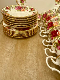 Set of floral teacups and saucers on a wooden surface