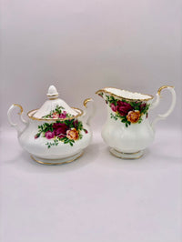 Tea set with floral design on a plain background