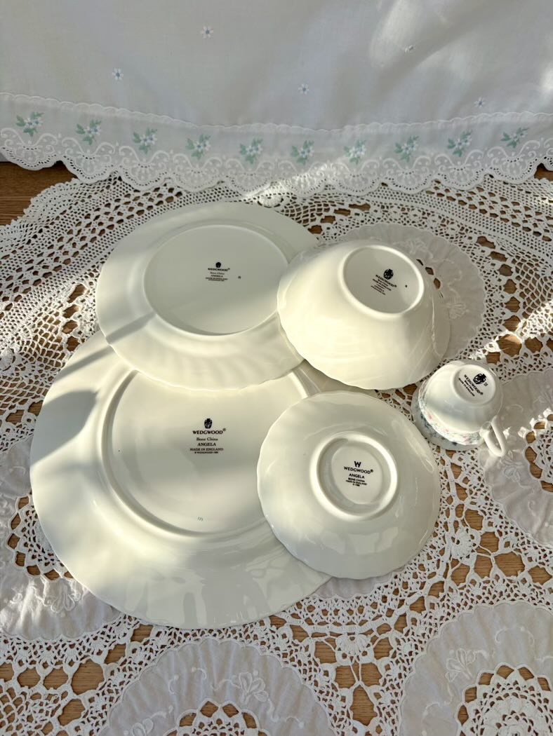 Set of white ceramic plates on a lace tablecloth