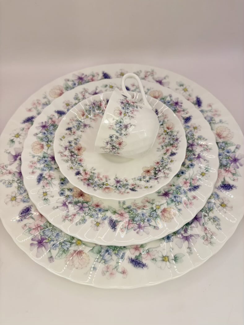 Set of ceramic dishes with floral patterns on a white background