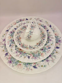 Set of ceramic dishes with floral patterns on a white background