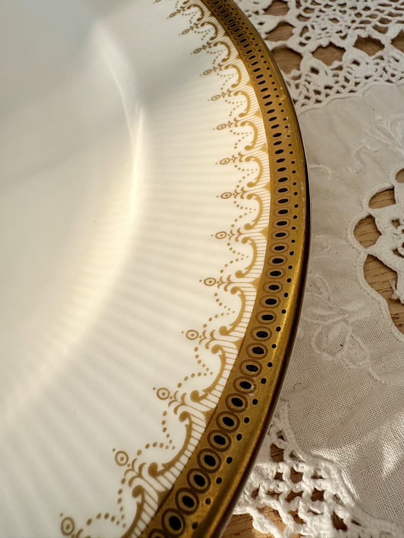 Decorative plate with gold rim on a lace doily