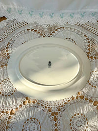 White oval plate on a lace tablecloth