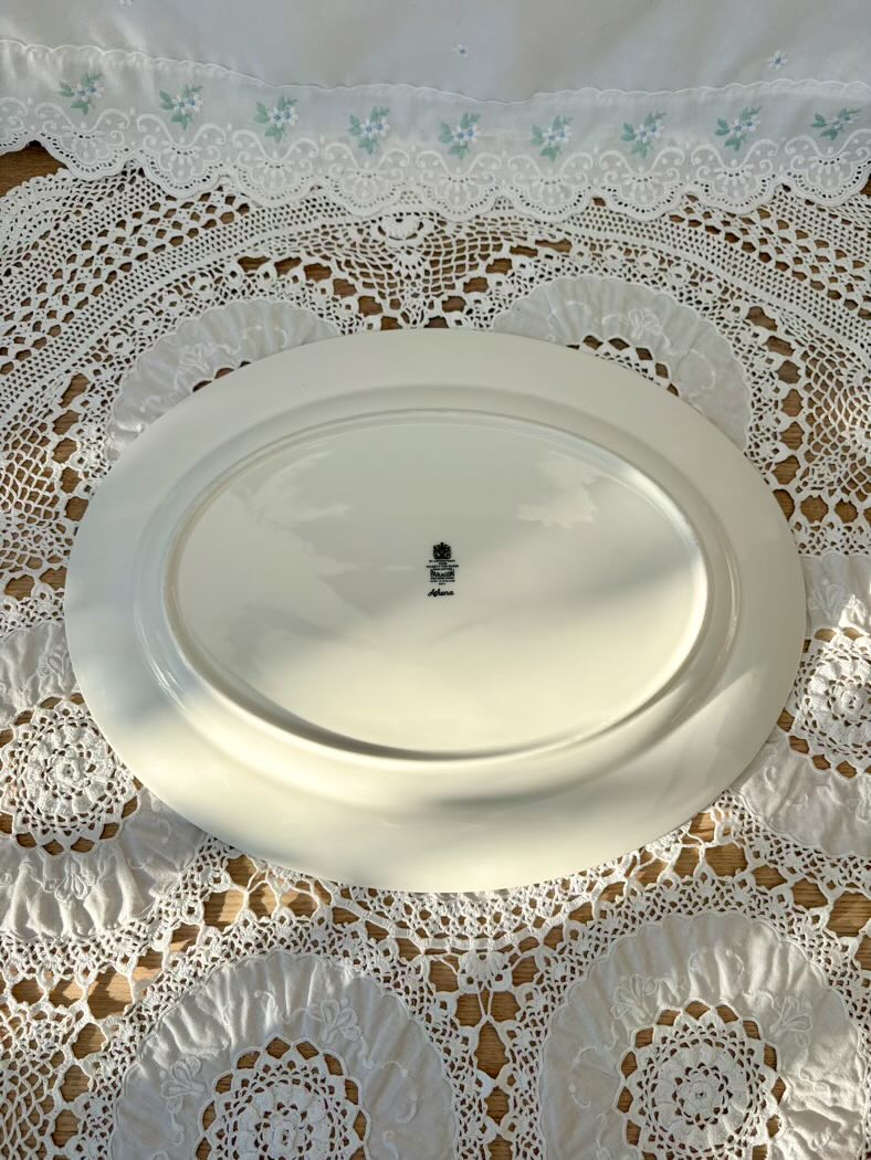 White oval plate on a lace tablecloth