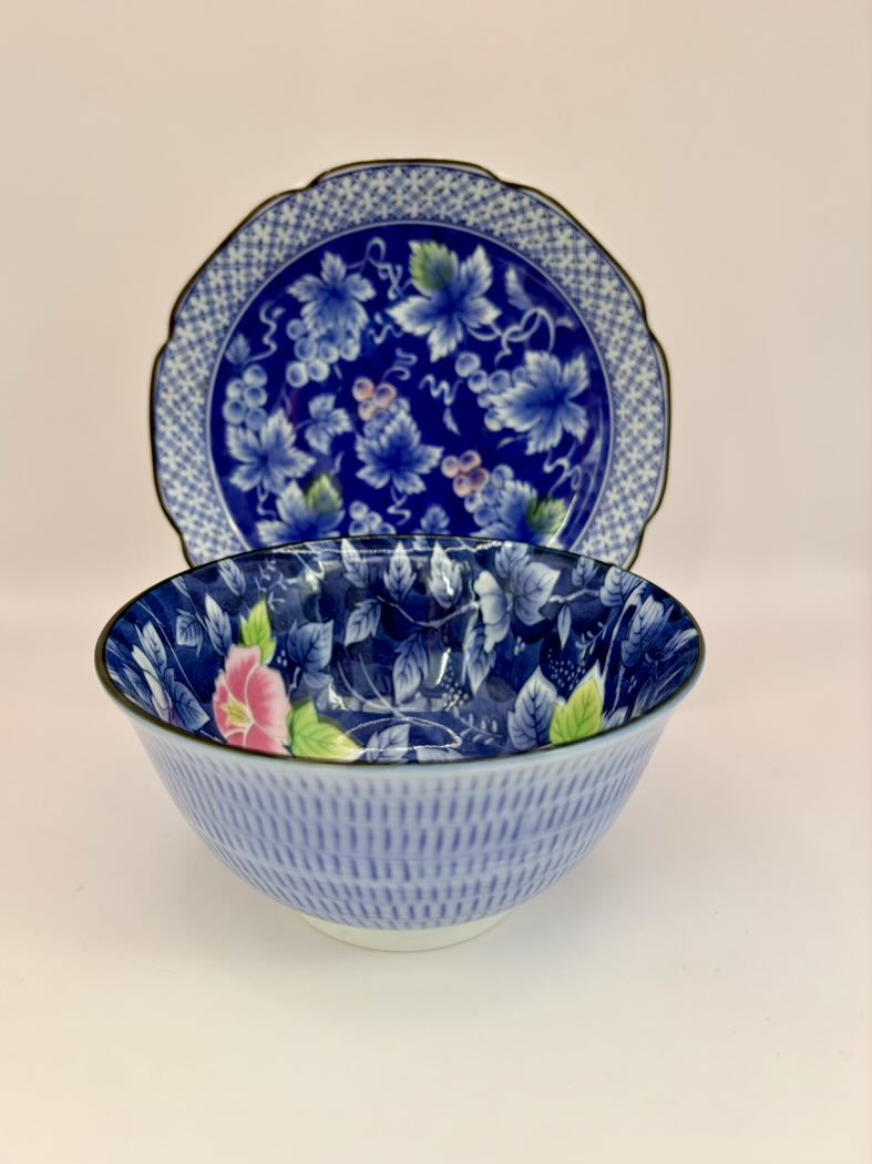 Blue floral ceramic bowl and plate set on a beige background