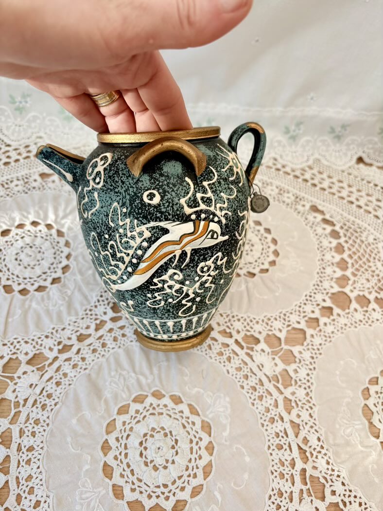 Decorative ceramic vase with artistic design on a lace tablecloth