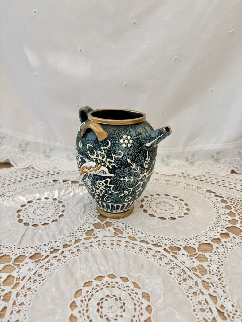 Decorative ceramic vase on a lace tablecloth