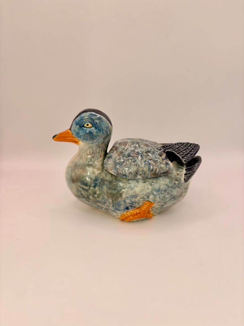 Decorative stone duck figurine on a light background