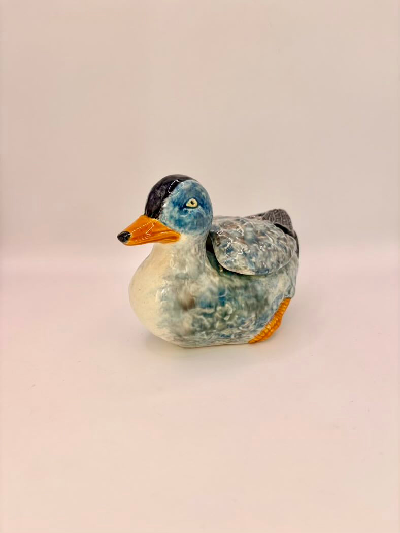 Decorative duck figurine on a light beige background