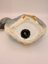 Decorative ceramic piece with 'Casa Pupo' branding on a light background