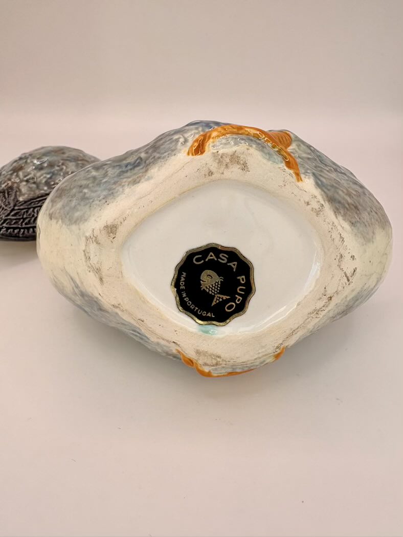 Decorative ceramic piece with 'Casa Pupo' branding on a light background