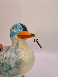 Arrow showing  small chip on the duck's noose