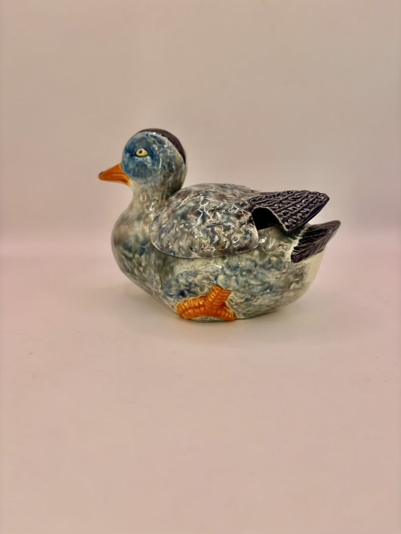 Ceramic duck figurine on a beige background