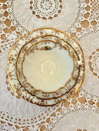 Decorative ceramic plate with gold trim on a lace doily