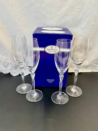 All four champagne flutes standing upright, showing their elegant tall shape and twisted stems