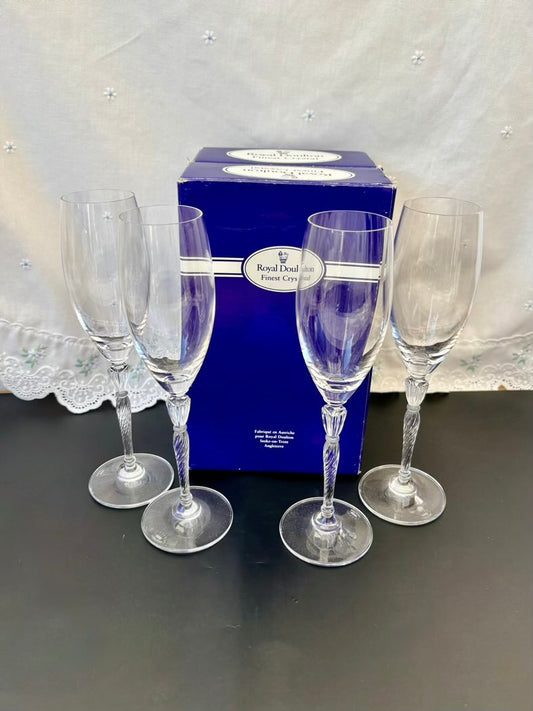 All four champagne flutes standing upright, showing their elegant tall shape and twisted stems
