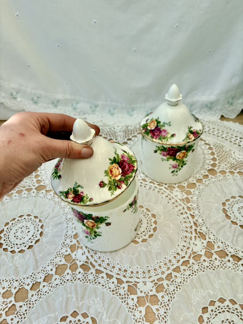 Decorative teacups with floral patterns on a lace tablecloth