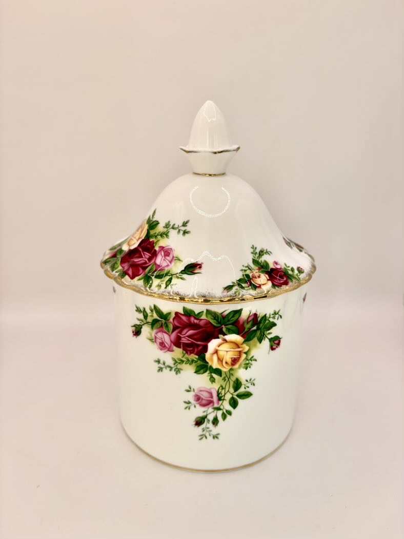 Decorative ceramic jar with floral patterns on a beige background