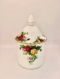 Decorative ceramic jar with floral patterns on a beige background