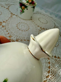 White ceramic container with a lid on a lace tablecloth