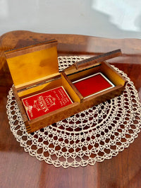 Wooden box with playing cards on a doily