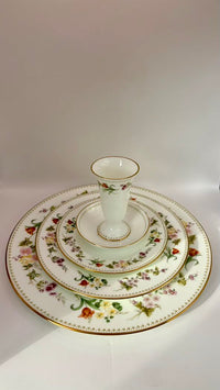 Set of decorative plates with a central vase on a white background