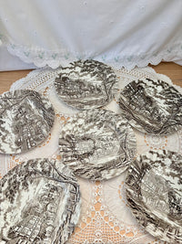 Decorative plates with intricate designs on a lace doily