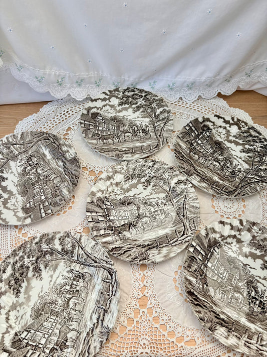 Decorative plates with intricate designs on a lace doily