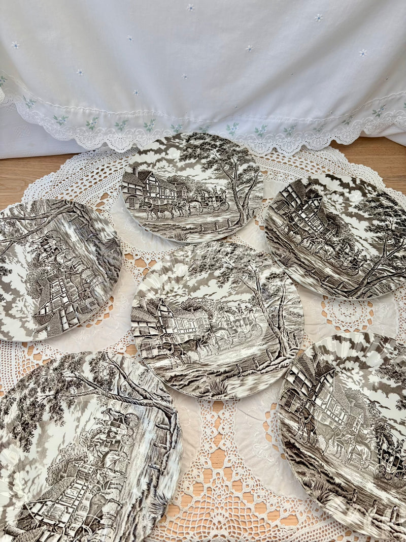 Decorative plates with intricate designs on a lace doily