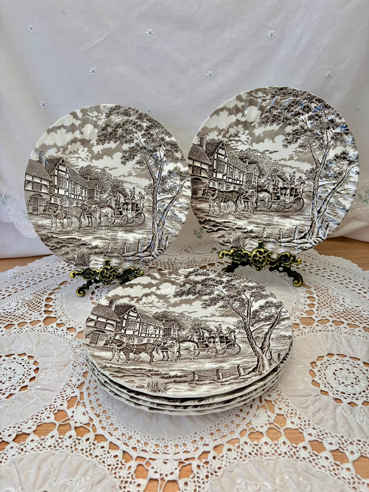 Set of decorative plates with landscape design on a lace tablecloth