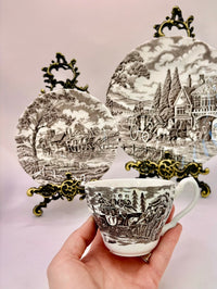 Tea set with scenic design on a light pink background