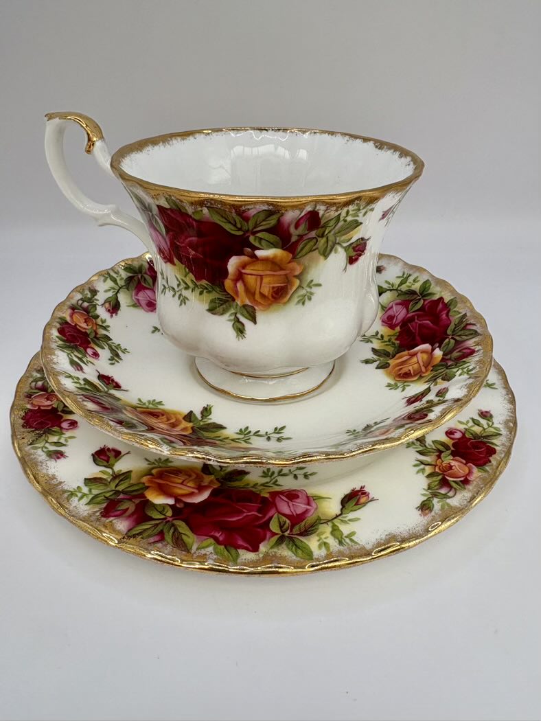 Floral teacup and saucer set with gold trim on a white background