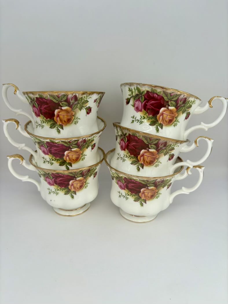 Set of six floral teacups with roses on a white background