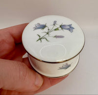 Round vintage porcelain trinket box with floral design and lid