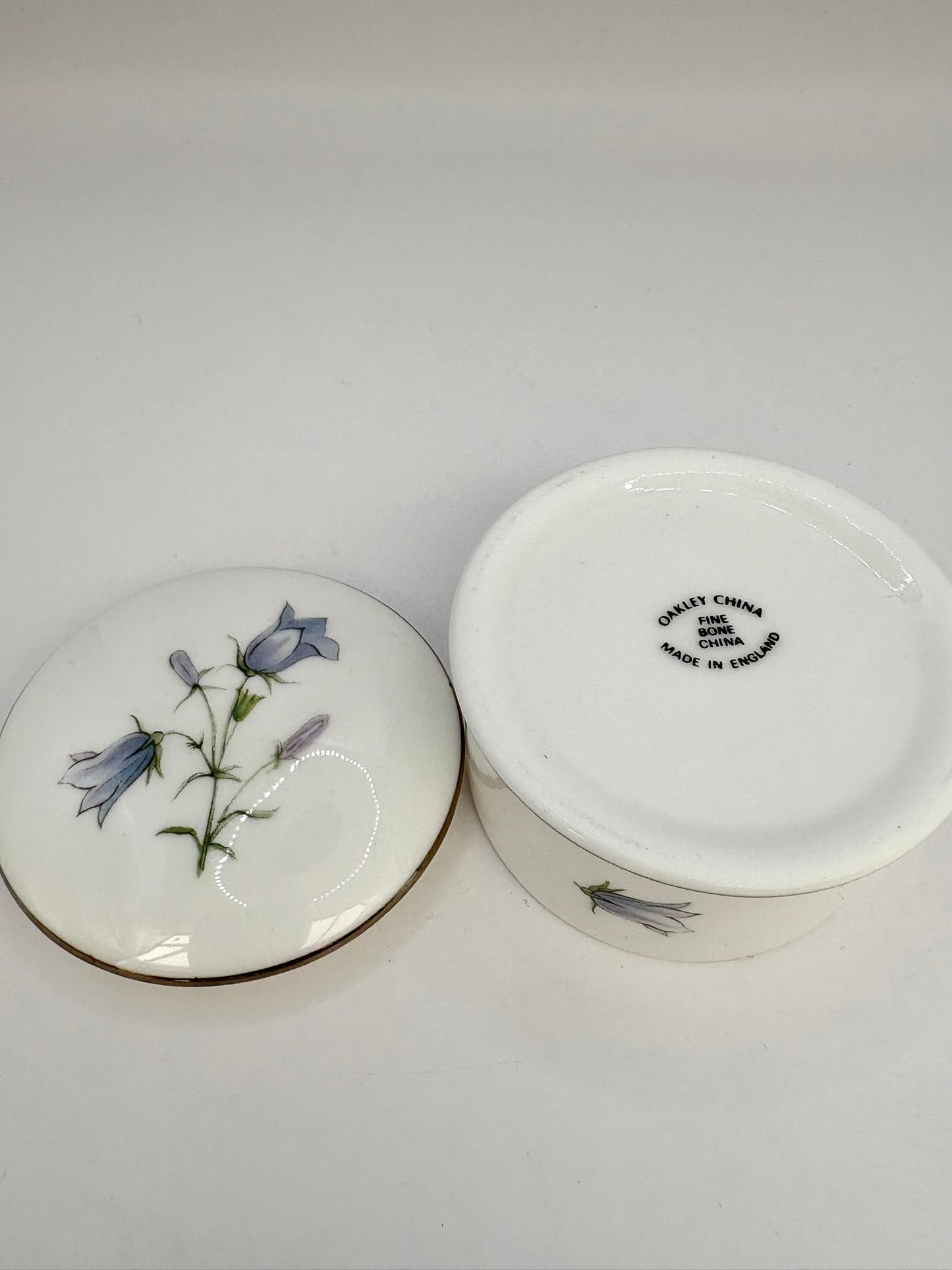 Round vintage porcelain trinket box with floral design and lid