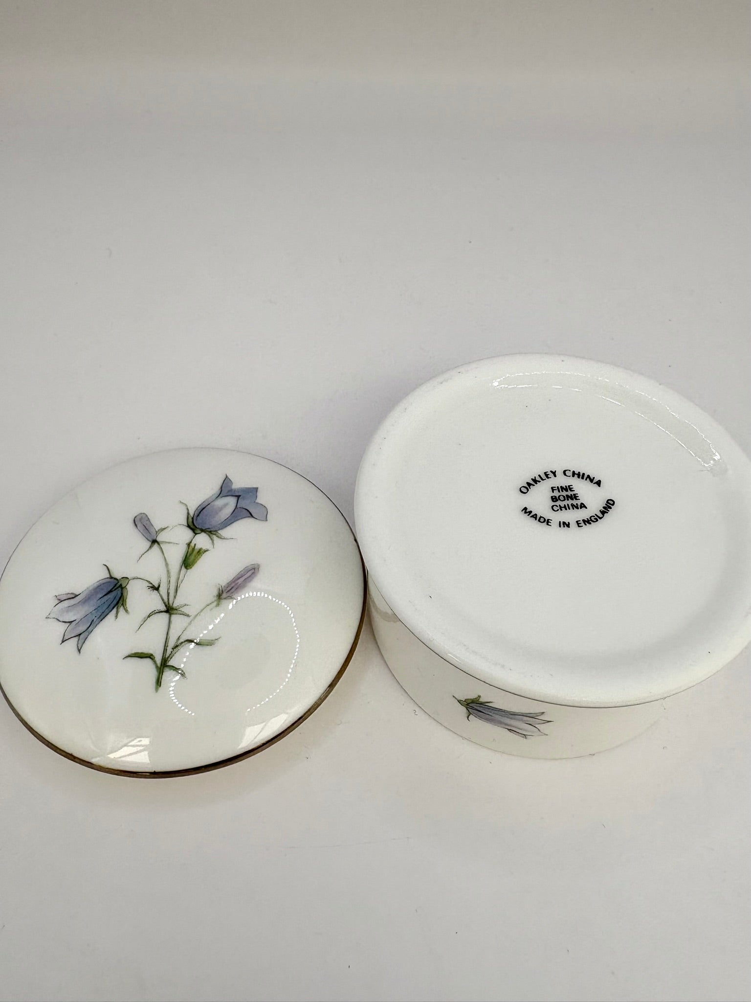 Round vintage porcelain trinket box with floral design and lid