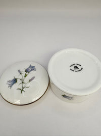Round vintage porcelain trinket box with floral design and lid