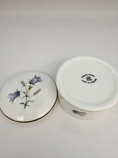 Round vintage porcelain trinket box with floral design and lid