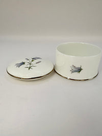 Round vintage porcelain trinket box with floral design and lid