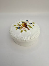 Porcelain trinket box with vintage bird design on lid, perfect for keepsakes