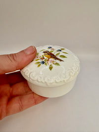 Porcelain trinket box with vintage bird design on lid, perfect for keepsakes