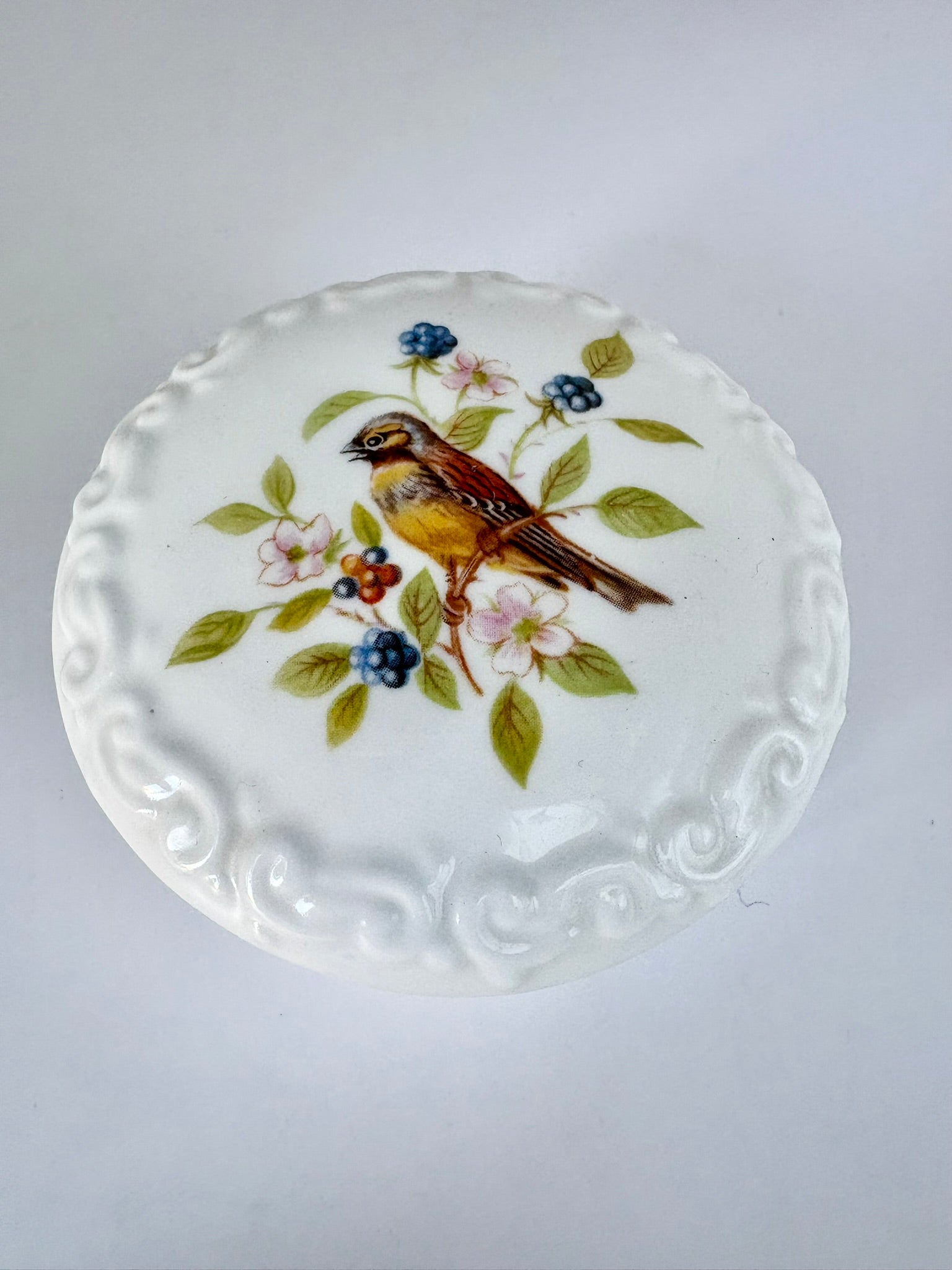 Porcelain trinket box with vintage bird design on lid, perfect for keepsakes