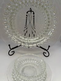 Vintage clear glass dessert set with diamond cut pattern, including bowls, saucers, and a serving plate