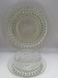 Vintage clear glass dessert set with diamond cut pattern, including bowls, saucers, and a serving plate